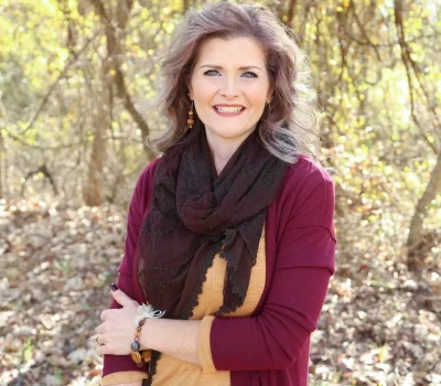 Gina Hoover, lead real estate agent at Team Hoover Realty Group, smiling outdoors in Burleson, Texas
